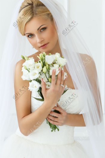 抱着花朵的性感新娘图片