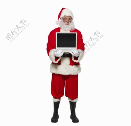 抱着笔记本电脑圣诞老人图片