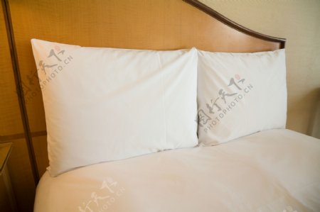 客房床上整洁的两个枕头图片