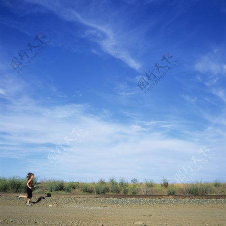 蓝天下跑步的女人图片